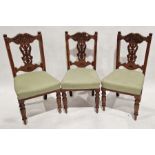 Set of three early 20th century oak dining chairs with pierced and carved splat backs and