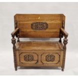 Oak monk's bench with carved scrolling foliate decoration to the seat, back and front panels,