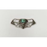 Cymric Liberty's Art Nouveau silver-coloured metal and turquoise brooch of scroll design with