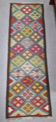 Blue ground Maimana kilim runner with one central row of nine lozenge floral medallions flanked by