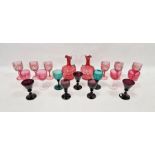 Two Victorian cranberry tinted honeycomb moulded ewers, six wine-glasses engraved with fruiting