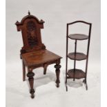 Victorian stained oak hall chair with ornate carved shield and scrolling motifs to the back, 97cm