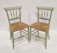 Pair of green and cream painted rush seated chairs with spindle backs and stretchers