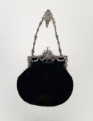 Edwardian silver hinged mounted black velvet evening bag, the hinge cast with swags of laurel and