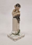 Royal Copenhagen figure of a faun with lizard on a fluted column, printed and painted blue and green