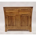 Modern oak cabinet with two fitted drawers above two door cupboard, the handles are moulded to fit
