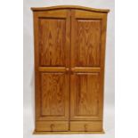 Modern pine two door wardrobe, above two short drawers, measuring approximately 176cm high x 101cm
