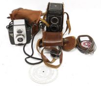 Rolleicord box camera in leather carrying case, a Brownie Reflex 20 camera in fibre case, a