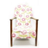 Mid twentieth century wingback oak framed armchair, upholstered in stylised poppy fabric, rush