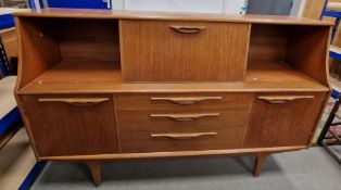 Mid 20th Century highboard / sideboard by Jentique, with central cocktail compartment flanked by