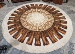 Large modern circular cream ground rug with central cog design 242cm