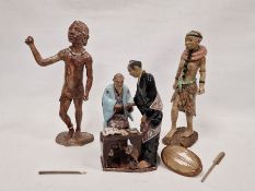 Chinese Shiwan figure group and two stone and resin tribal figures, the first modelled as two men in