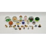 Eleven assorted modern paperweights and a small collection of Wade Whimsies, the paperweights