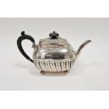 Late Victorian silver teapot, with wooden handle and knob to lid, half gadrooned body on four bun