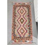 Chobi kilim runner with three central stepped lozenge medallions on geometric field, single