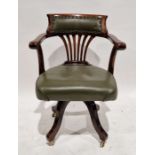 Shoolbred and Co mahogany captain's swivel armchair with a leather upholstered back and seat on