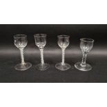 Four 18th century drinking glasses, including: two with opaque twist and gauze stems, another with