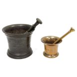 Cast metal mortar and pestle, the mortar 14cm high with flared rim and a small copper-coloured