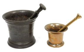 Cast metal mortar and pestle, the mortar 14cm high with flared rim and a small copper-coloured