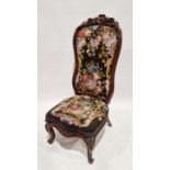 19th century rosewood framed high-back bedroom chair with carved floral motifs throughout and floral