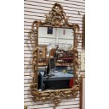 Large 19th century giltwood framed wall hanging mirror of rectangular form, decorated throughout