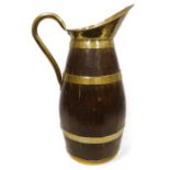 Brass-bound oak jug, floor standing, with brass lip and handle, 71cm high