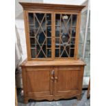 Pine display cabinet, the glazed top with shaped shelves, cupboard below, on bracket feet, 120cm