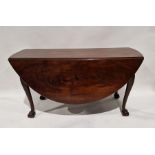 Late Georgian mahogany swingleg dining table of oval form, raised on cabriole legs with claw and