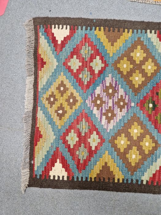 Blue ground Maimana kilim runner with one central row of nine lozenge floral medallions flanked by - Image 6 of 8