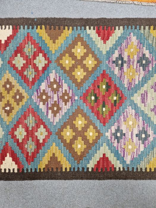 Blue ground Maimana kilim runner with one central row of nine lozenge floral medallions flanked by - Image 5 of 8