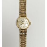 Lady’s 9ct gold Roamer wristwatch with circular dial, baton numerals and the flexible mesh 9ct
