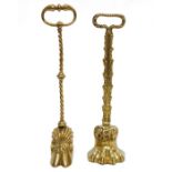 Brass claw and feather-pattern doorstop with loop handle and another with cloven hoof (2)