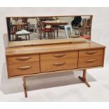 Austinsuite teak dressing table, with long hinged mirror back over six drawers, each with curved