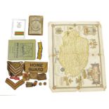 WWII medal in glazed case, sundry arm badges and ribbons, a Philips old card map of England stamp