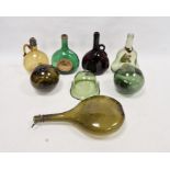 Five 19th/early 20th century green and straw tinted glass bottles, two green tinted witches balls