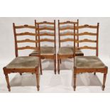 Four pine ladderback dining chairs, with carved detail to the top rail, turned front supports,