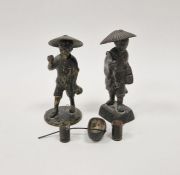 Two Japanese late Meiji (1869-1912) bronze figures of farmers, each modelled wearing a wide-