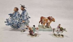 Pair of German small porcelain figures with cattle, modelled carrying baskets of grapes and flowers,