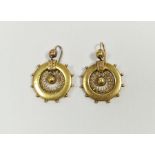 Pair of Victorian gold coloured metal pendant drop earrings in the form of circular ship's wheel