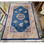 Chinese blue ground superwash rug with central floral medallion, floral spandrels and single