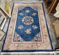 Chinese blue ground superwash rug with central floral medallion, floral spandrels and single