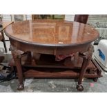 Mahogany extending dining table, circular, on foliate and shell carved turned supports, claw and