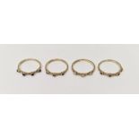 Set of four 9ct gold half-hoop rings, each set with miniature cabochon four sapphires, four garnets,