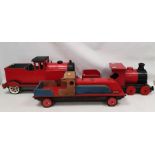 Three large painted wooden locomotives to include a red and blue locomotive a red and black