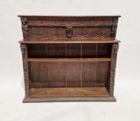 19th century carved oak bookcase, the raised back carved scrolled lunettes flanked by carved