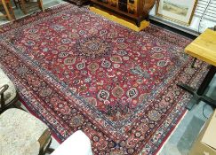 Large Persian carpet with central floral medallion on floral field with hanging baskets, floral