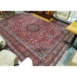 Large Persian carpet with central floral medallion on floral field with hanging baskets, floral