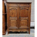 French fruitwood armoire enclosed by two shaped panel doors enclosing shelves, 157cm high x 120cm
