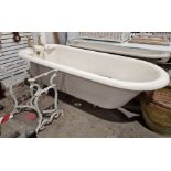 Vintage cast iron roll-top bath . 208 cms long, with brass taps and integral soap dishes and a