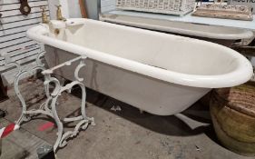 Vintage cast iron roll-top bath . 208 cms long, with brass taps and integral soap dishes and a